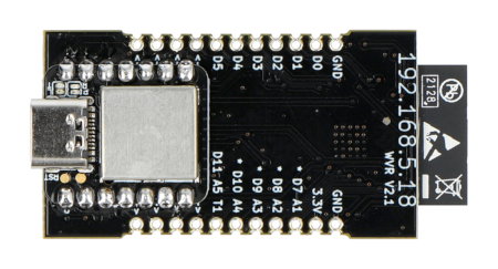 Czarna płytka rozwojowa SparkFun leży odwrócona na białym tle.